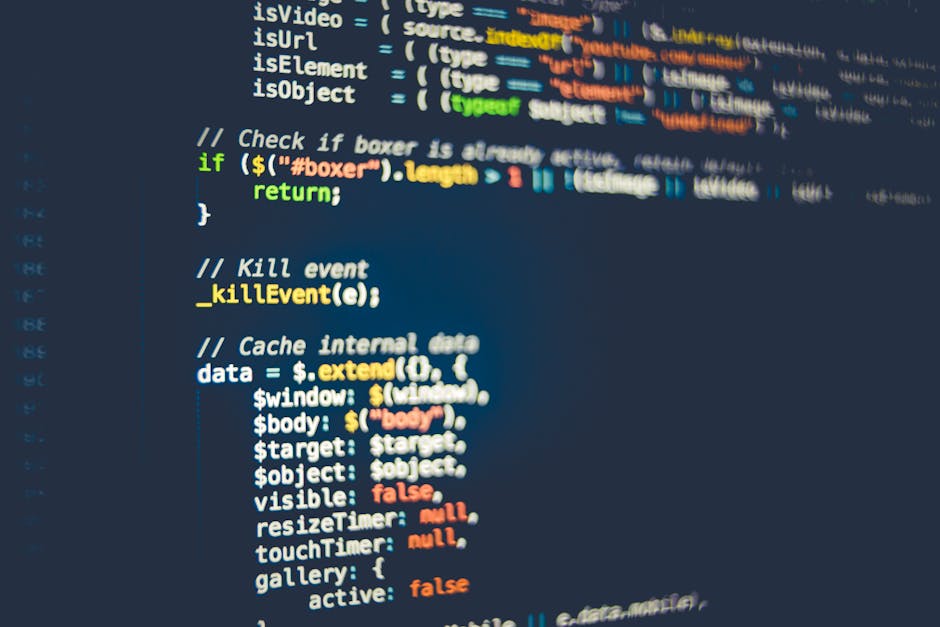 Close-up photograph of a computer screen displaying lines of code with syntax highlighting in various colors. The code includes HTML tags and attributes, such as <div>, <span>, and class names, with s